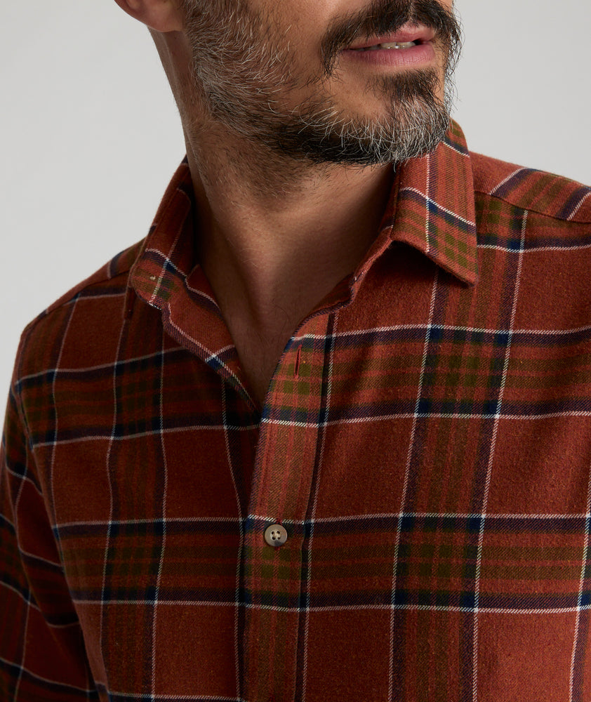 Model is wearing UNTUCKit Flannel Regner Shirt in Burnt Red Plaid.