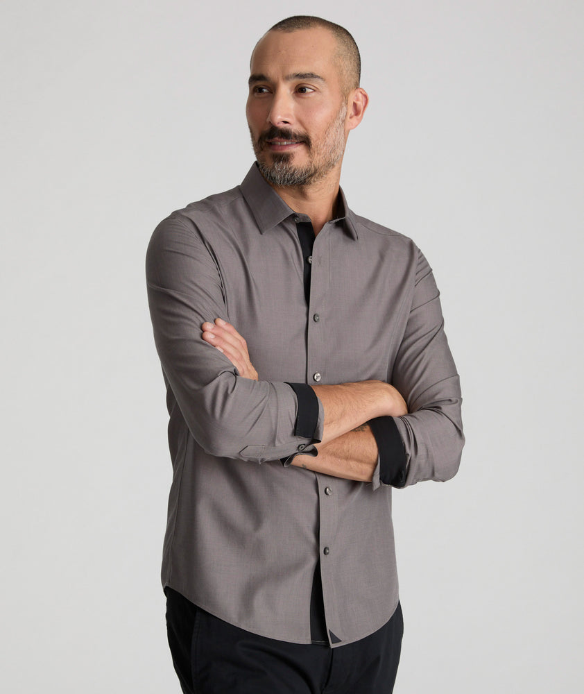 Model is wearing UNTUCKit Ribinson wrinkle-free shirt in solid gray with contrast cuff. 