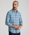 Model is wearing UNTUCKit Flannel Salentino Shirt in Light Blue Heathered Plaid.