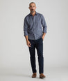 Model is wearing UNTUCKit Classic Chino Pants in Navy.