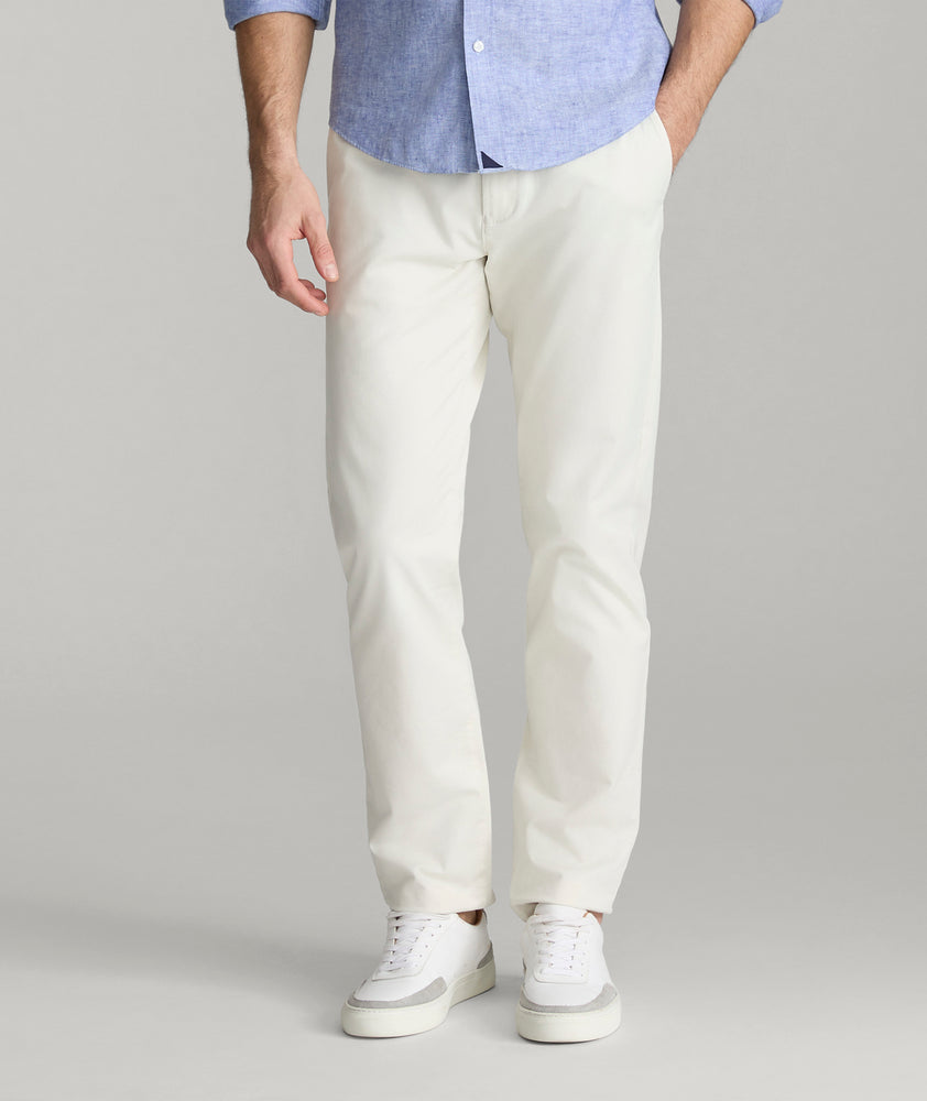 Model is wearing UNTUCKit Classic Chino Pants in Stone Gray.