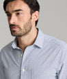 Model is wearing UNTUCKit Wrinkle-Free Performance Teramo Shirt in White & Navy Print.