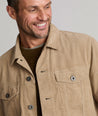 Model is wearing UNTUCKit Tibouren cord trucker jacket in khaki.