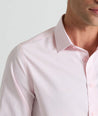 Model is wearing UNTUCKit Travels shirt in tiny pink gingham. 