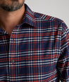 Model is wearing UNTUCKit Wrinkle-Free Performance Flannel Trezari Shirt in Navy Red & White Plaid.