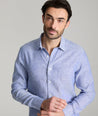 Model wearing an UNTUCKit Mid Blue Wrinkle-Resistant Linen Vin Santo Shirt