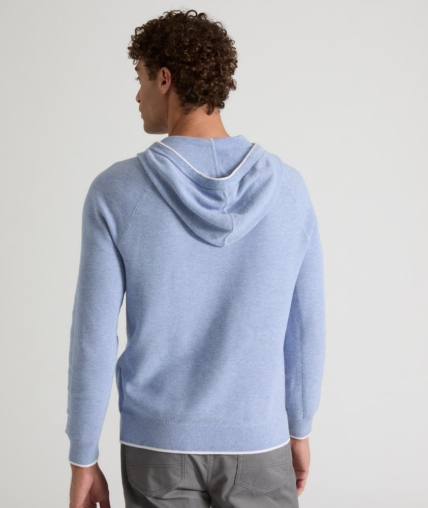 Model is wearing UNTUCKit Walcott cotton hoodie in heather blue. 