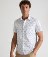 Model is wearing UNTUCKit ward short sleeve shirt in white floral print. 