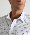 Model is wearing UNTUCKit ward short sleeve shirt in white floral print. 