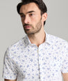 Model is wearing UNTUCKit ward short sleeve shirt in white floral print. 