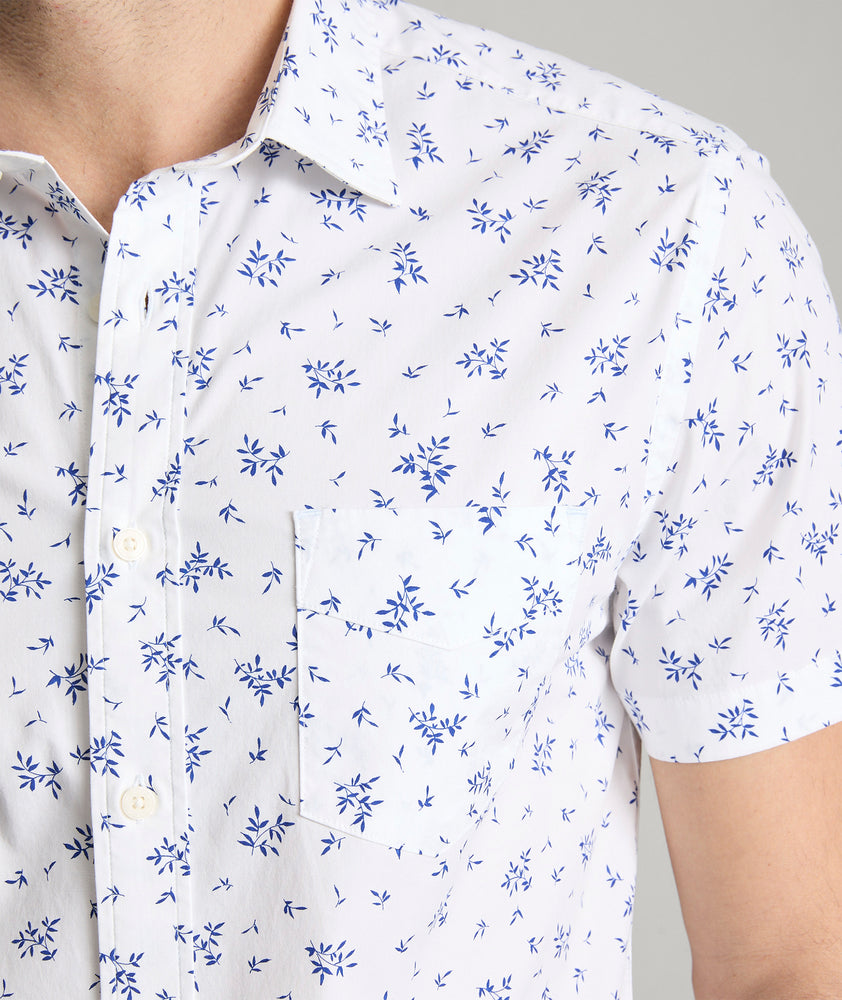 Model is wearing UNTUCKit ward short sleeve shirt in white floral print. 