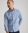 Model is wearing UNTUCKit weaver shirt in blue and white plaid. 