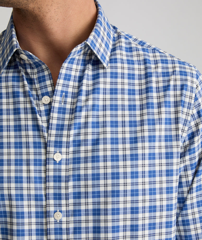 Model is wearing UNTUCKit weaver shirt in blue and white plaid. 