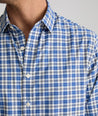 Model is wearing UNTUCKit weaver shirt in blue and white plaid. 