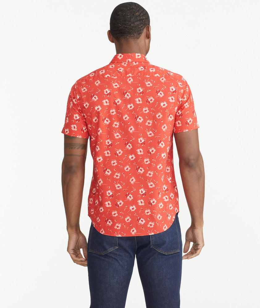 Model is wearing UNTUCKit Poppy Red Print Cotton Short-Sleeve Coolidge Shirt.