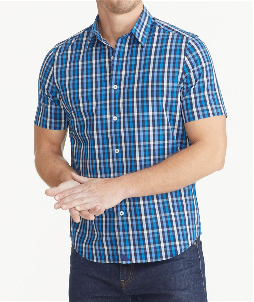 Model is wearing UNTUCKit Dark Blue Cotton Short-Sleeve Check Shirt.