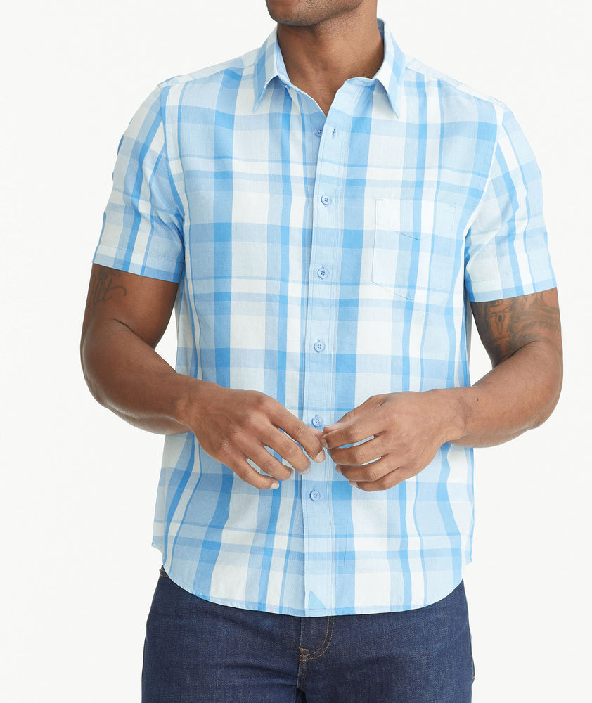 Model is wearing UNTUCKit Blue Cotton Short-Sleeve Plaid Shirt.