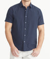 Model is wearing UNTUCKit Navy Cotton Seersucker Short-Sleeve Pavao Shirt.