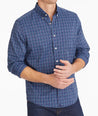 Model wearing an UNTUCKit Navy Wrinkle-Free Performance Vesparo Shirt